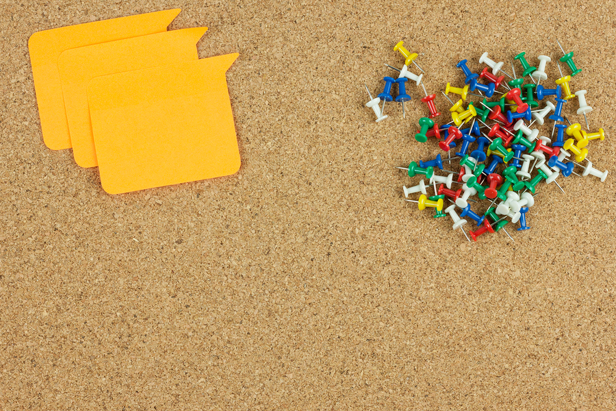 bulletin board, push pins and notes